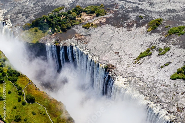 Fototapeta Victoria Falls from aerial view. Waterfall in southern Africa on the Zambezi River at the border between Zambia and Zimbabwe. Rainbow on the river. 