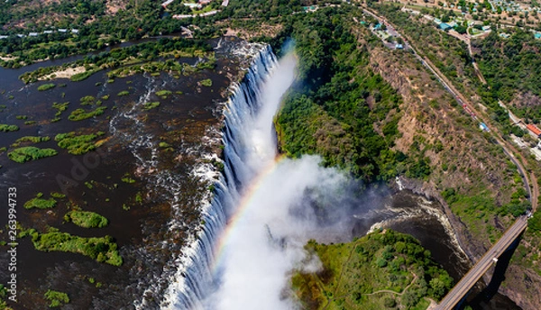 Fototapeta Victoria Falls from aerial view. Waterfall in southern Africa on the Zambezi River at the border between Zambia and Zimbabwe. Rainbow on the river. 