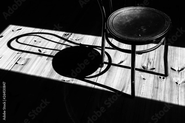 Obraz a chair forms a shadow from the sun