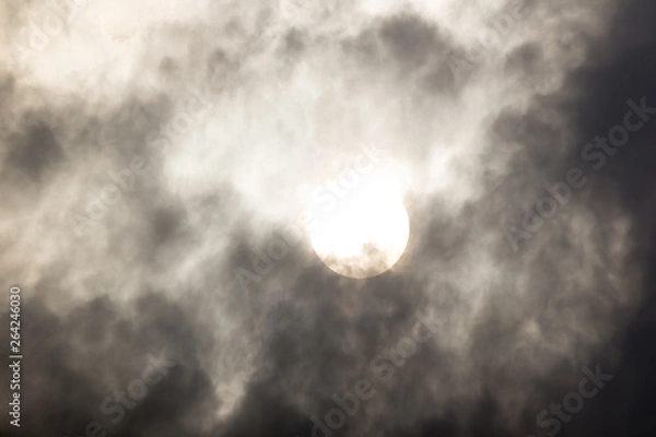 Fototapeta the sun hide behind grey cloud