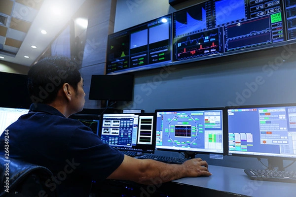 Obraz Engineer looking to work in the electrical control room