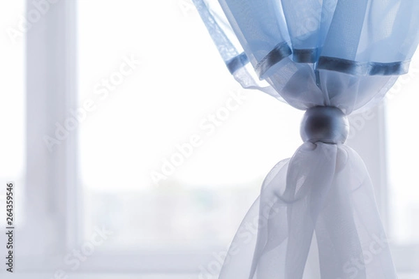 Obraz blue curtains are decorated with a decorative ring. comfort in the room.