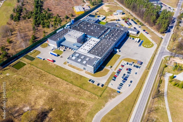 Fototapeta Distribution logistics buildings and industrial area - aerial view