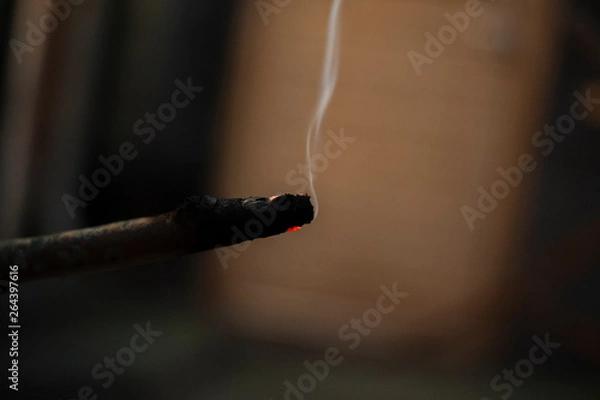 Fototapeta burning piece of wood with abstract background