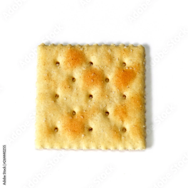 Obraz Looking down at one saltine, also known as soda and soup crackers, over white, not isolated.
