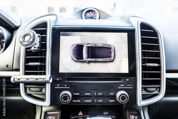 Obraz Top view, Display in interior of luxury car shows working of four cameras in surround view  assist system. 360 degrees Image display on the head unit. Multimedia in the car.