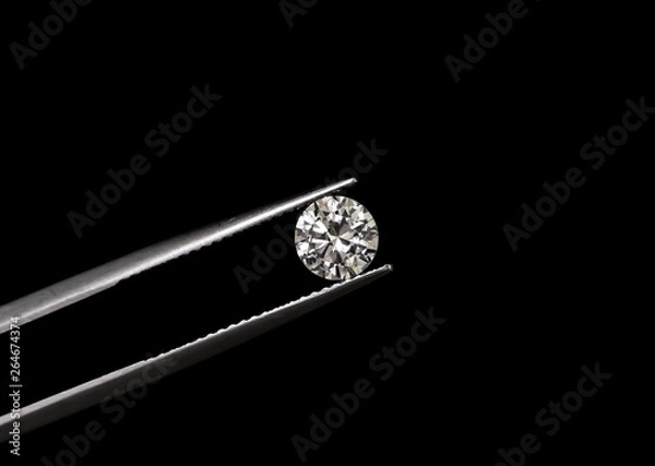 Obraz Diamond round shape in tweezers.