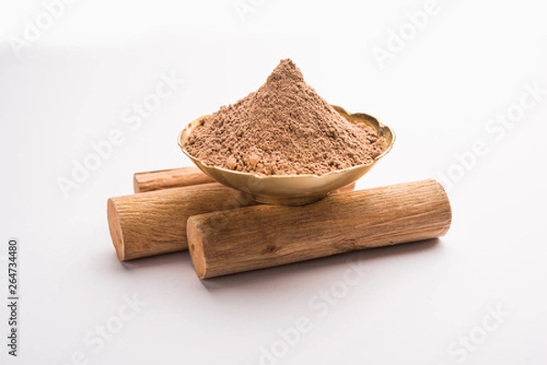 Obraz Chandan or sandalwood powder with sticks and green leaves