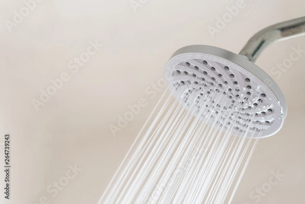Fototapeta Close up of a Shower head with running water. concept of hygiene and healthcare