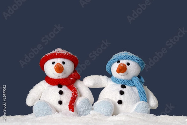 Obraz two cute snowmen sitting in the snow
