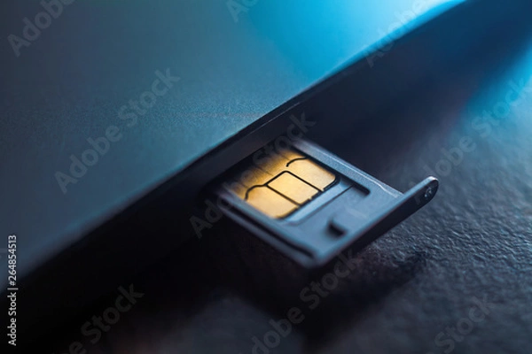 Fototapeta Sim card in tray being inserted into phone