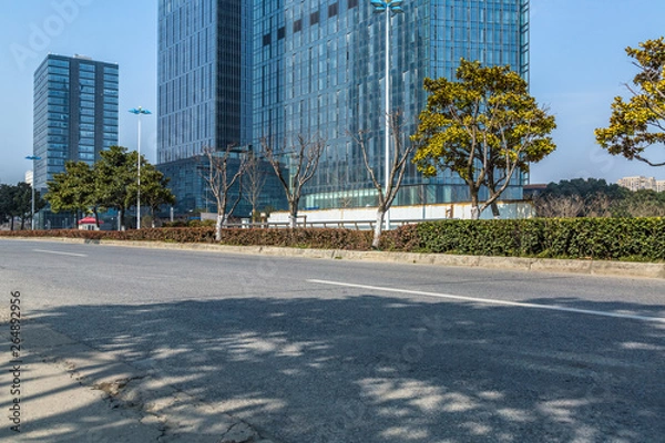 Fototapeta empty asphalt road front of modern buildings.
