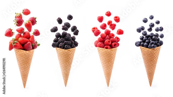 Fototapeta In the foreground, lively variety of berries in ice cream cones, isolated from the white background