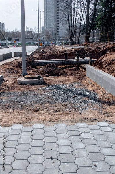 Obraz Repair the road. On the sidewalk lay tile.