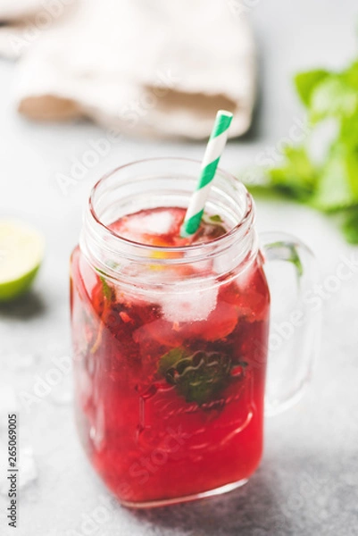 Fototapeta Berry Ice Tea In Glass Cup With Drinking Straw. Selective Focus, Vertical Orientation
