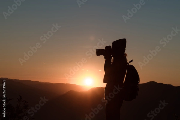 Obraz The photographer's silhouette with his camera on a sunset