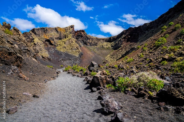 Fototapeta Spain, Lanzarote, Hiking path inside el cuervo crater of famous volcano tourist destination