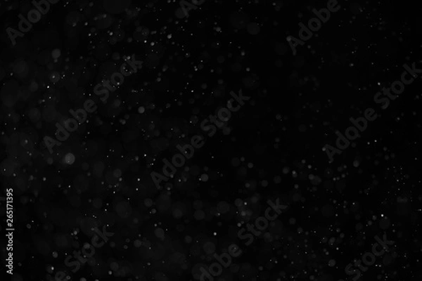Fototapeta Abstract real dust floating over black background