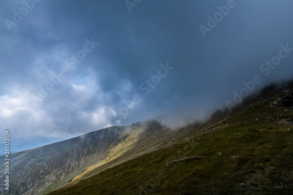 Fototapeta Mist and storm clouds in the mountains, in summer