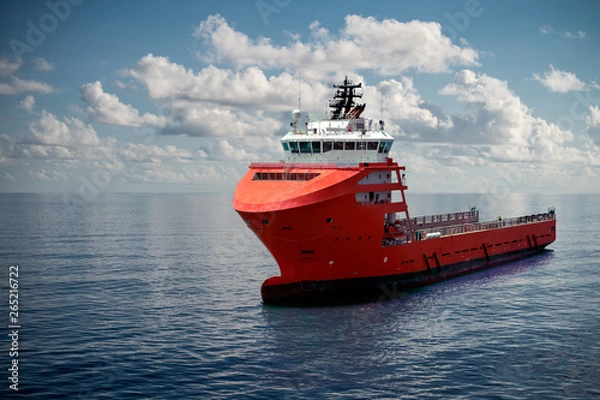 Obraz Offshore supply boat at sea during nice calm weather performing duties. Compositing technique.