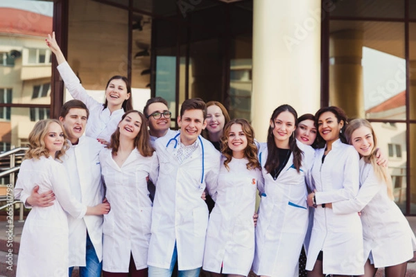 Obraz Education and health. general practitioner. A group of smart medical students in college. Friends interns on the background of the hospital.
