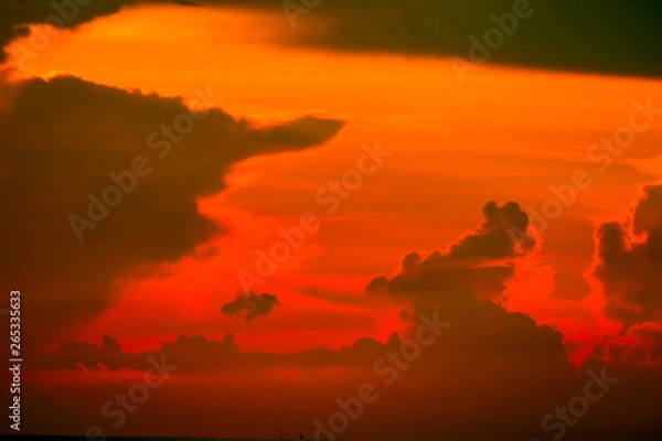 Fototapeta colorful of sunrise on silhouette cloud sky fishing boat and on sea island