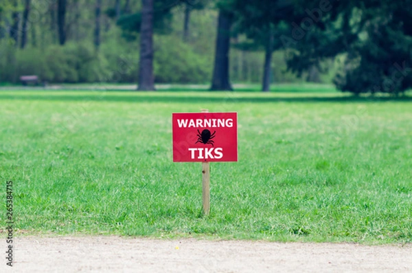 Fototapeta The sign on the lawn with the inscription: warning ticks