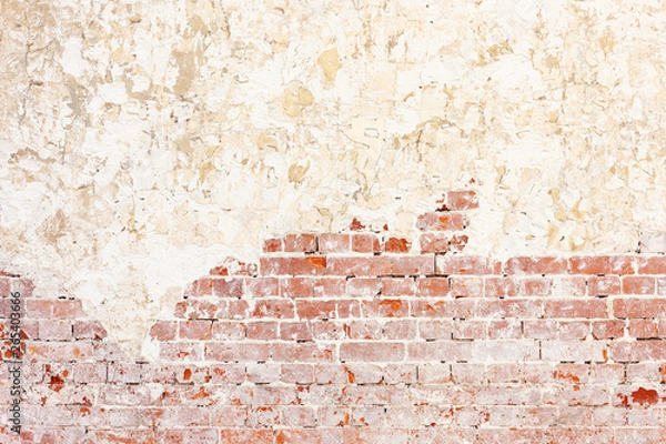 Fototapeta Red Old Weathered Brick Wall With Beaten Pieces Of Whitewash, Putty And Plaster. Fragment Of Wall Surface Of Historic Building With Chips, Cracks And Damages.