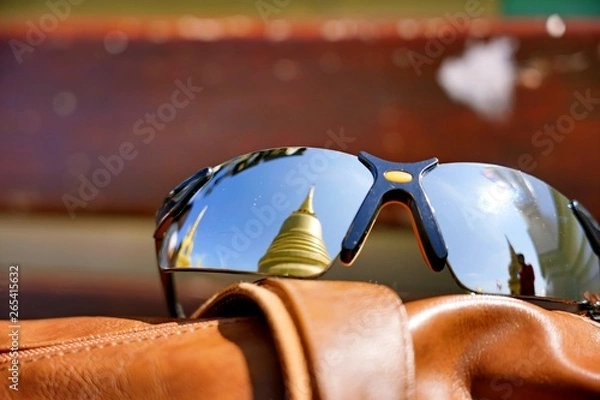 Fototapeta The reflection on a traveller's sunglasses at Wat Saket. This place is a landmark of Bangkok Thailand