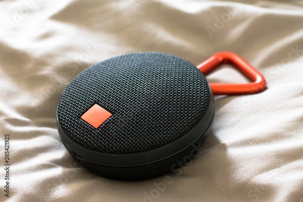 Fototapeta Round bluetooth speaker on the bed