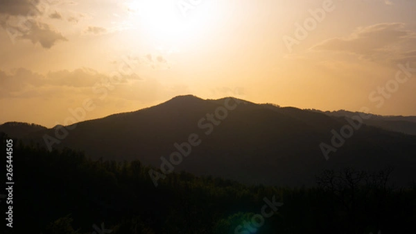 Fototapeta Beautiful landscape in the mountains at sunset. View of colorful sky with amazing clouds.