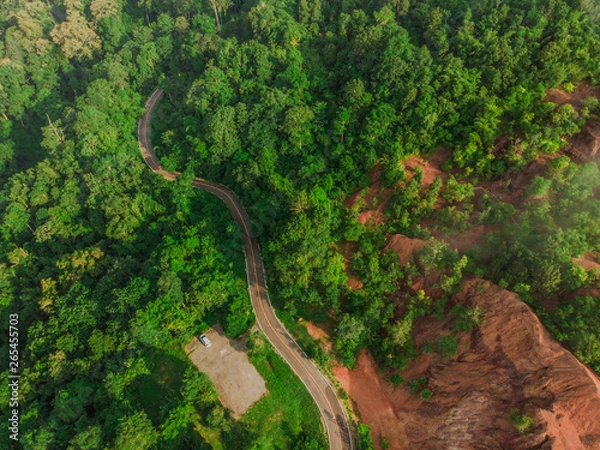 Fototapeta Top View of Rural Road, Path through the green forest and countryside of Thailand, Top view aerial photo from drone