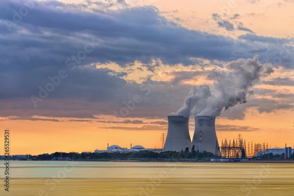 Obraz Riverbank with nuclear power plant Doel during a sunset with dramatic cluds, Port of Antwerp, Belgium