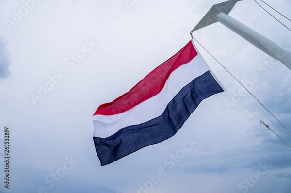 Fototapeta Waving flag of the Netherlands fixed to yacht mast