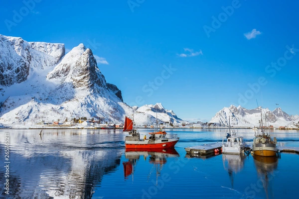 Fototapeta Fishing boat approaches the shore after a working day in the Lofoten Islands