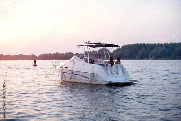 Obraz Young attractive people having good time on a boat with drinks
