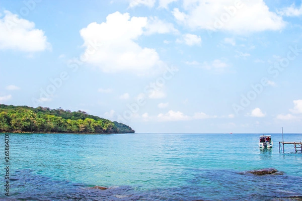 Fototapeta Ocean view crystal clear water from Haad Sai Daeng Beach which has wooden bridge for transfer tourists on Koh Kood island, Trat Thailand.
