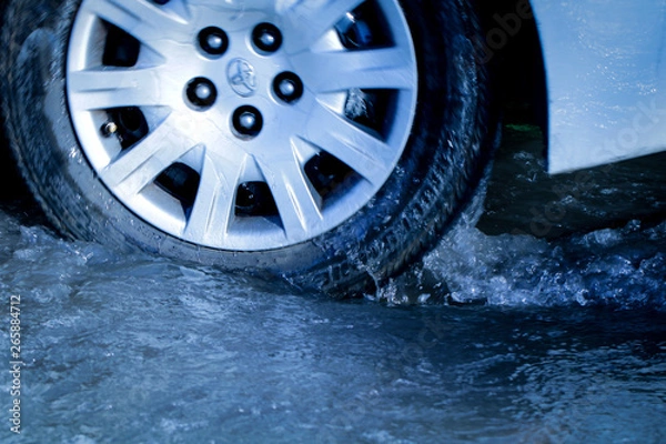 Obraz close up car tire in puddle 
