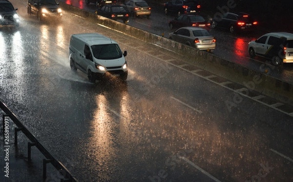 Fototapeta delivery van speeding by highway in rainy night