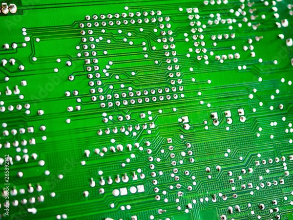 Fototapeta Close-up of printed electronic circuit board with processor and many integrated electrical components. Nanotechnology hardware system. Modern digital science concept. CPU welding or assembled on PCB.