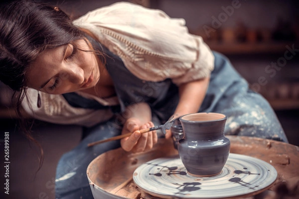 Fototapeta Stylish pottery woman enjoying pottery art and production process. The concept of craft creativity.