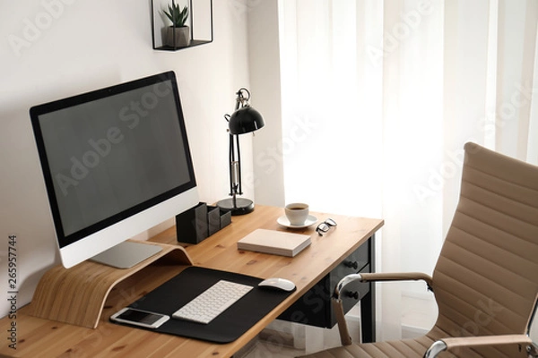 Fototapeta Stylish workplace interior with modern computer on table. Mockup for design