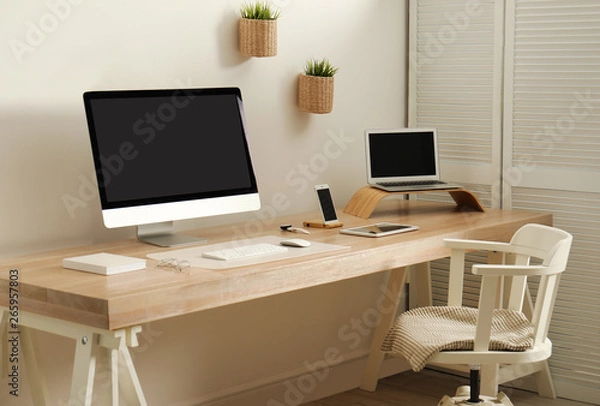 Fototapeta Stylish workplace interior with modern computer on table. Mockup for design