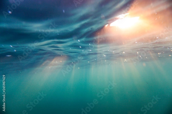Fototapeta Bright beams of sunlight refracting through the surface of the atlantic ocean.