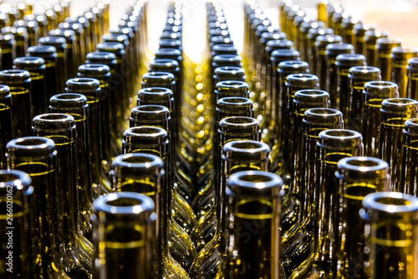 Fototapeta Large group of green recycled glass wine bottles in sunny day