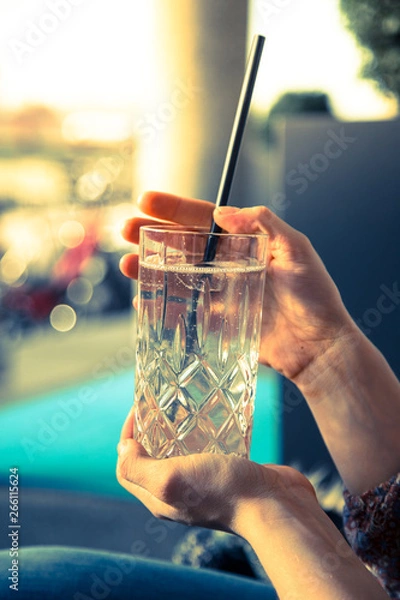 Fototapeta Refreshing drink in the summer: Girl is holding glass with cold beverage