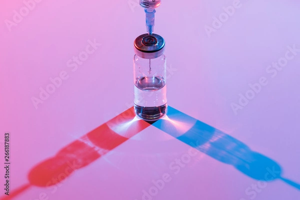 Fototapeta Glass bottle with vaccine and syringe for injection.