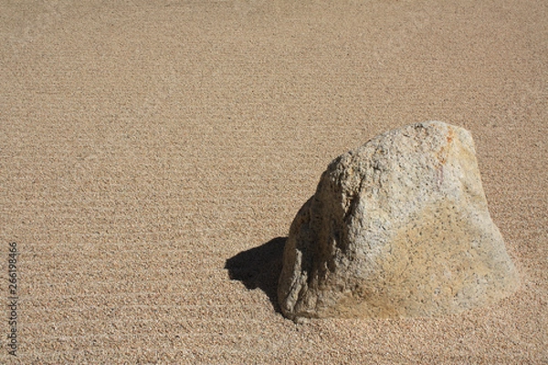 Fototapeta Sand with texture and design with a big rock