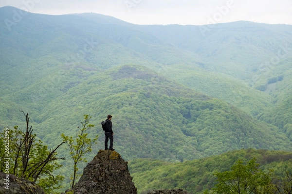 Fototapeta Boy standing on a cliff