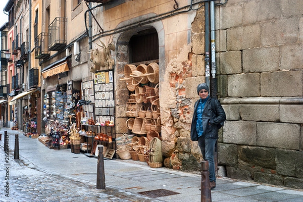 Fototapeta Tourist walking in front of souvenir shops at Segovia the historic city Romanesque architecture locate at northwest of Madrid, Spain.